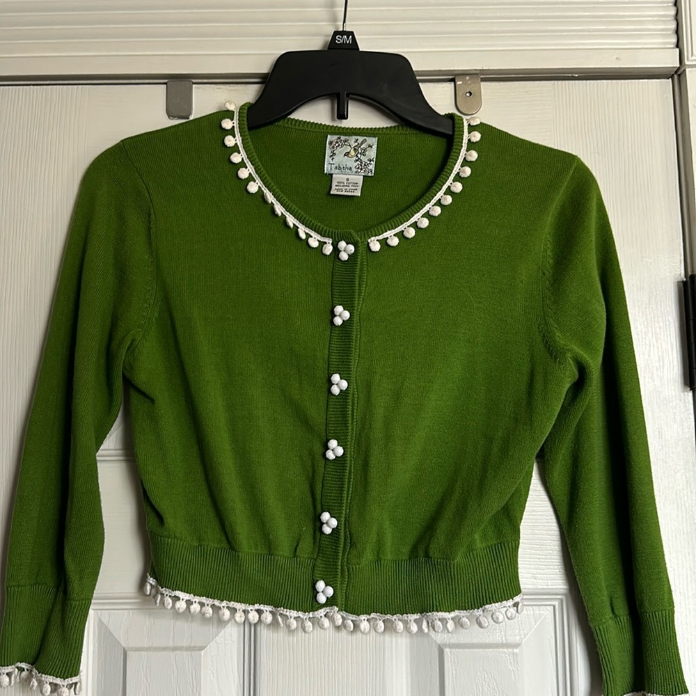 Tabitha Green cropped cardigan sweater with snap closure and white pom-poms.